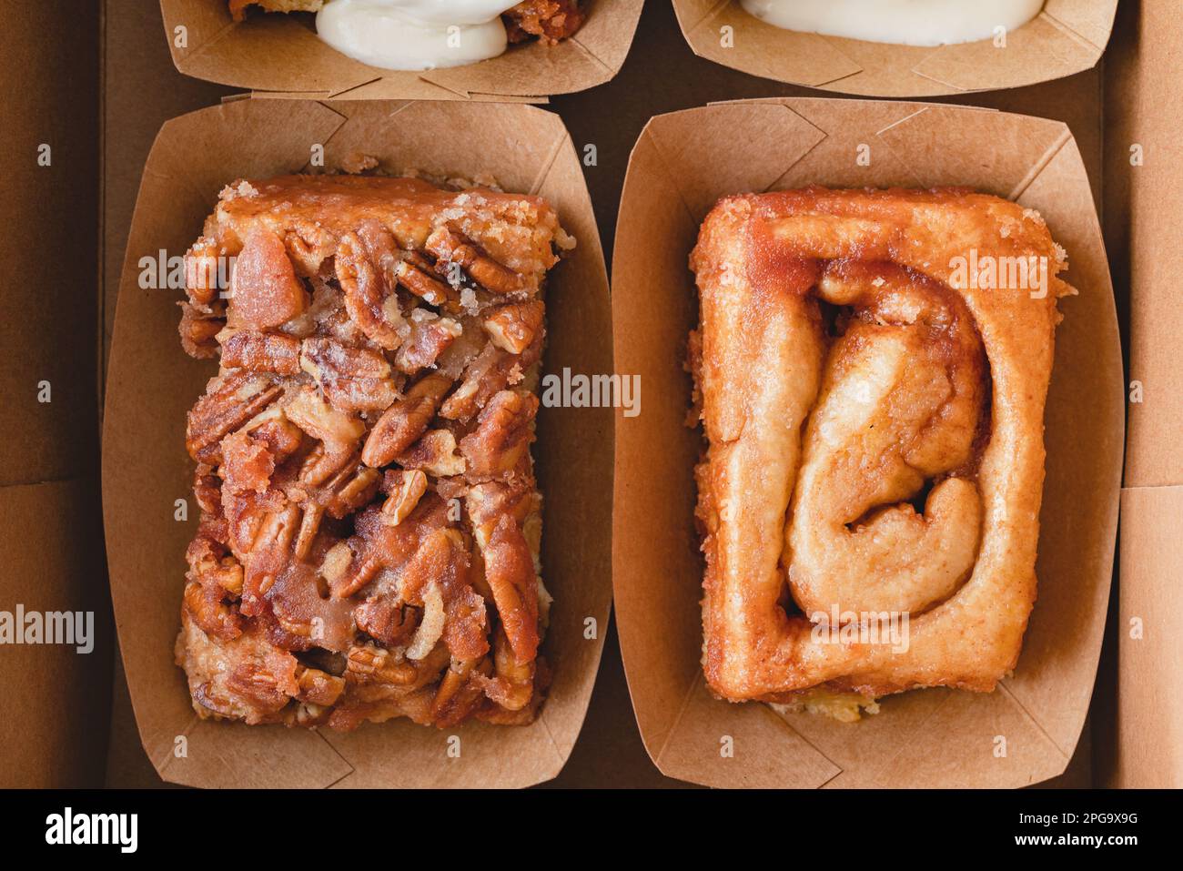 Pecan cinnamon roll, and Original cinnamon roll close up, flat lay Stock Photo