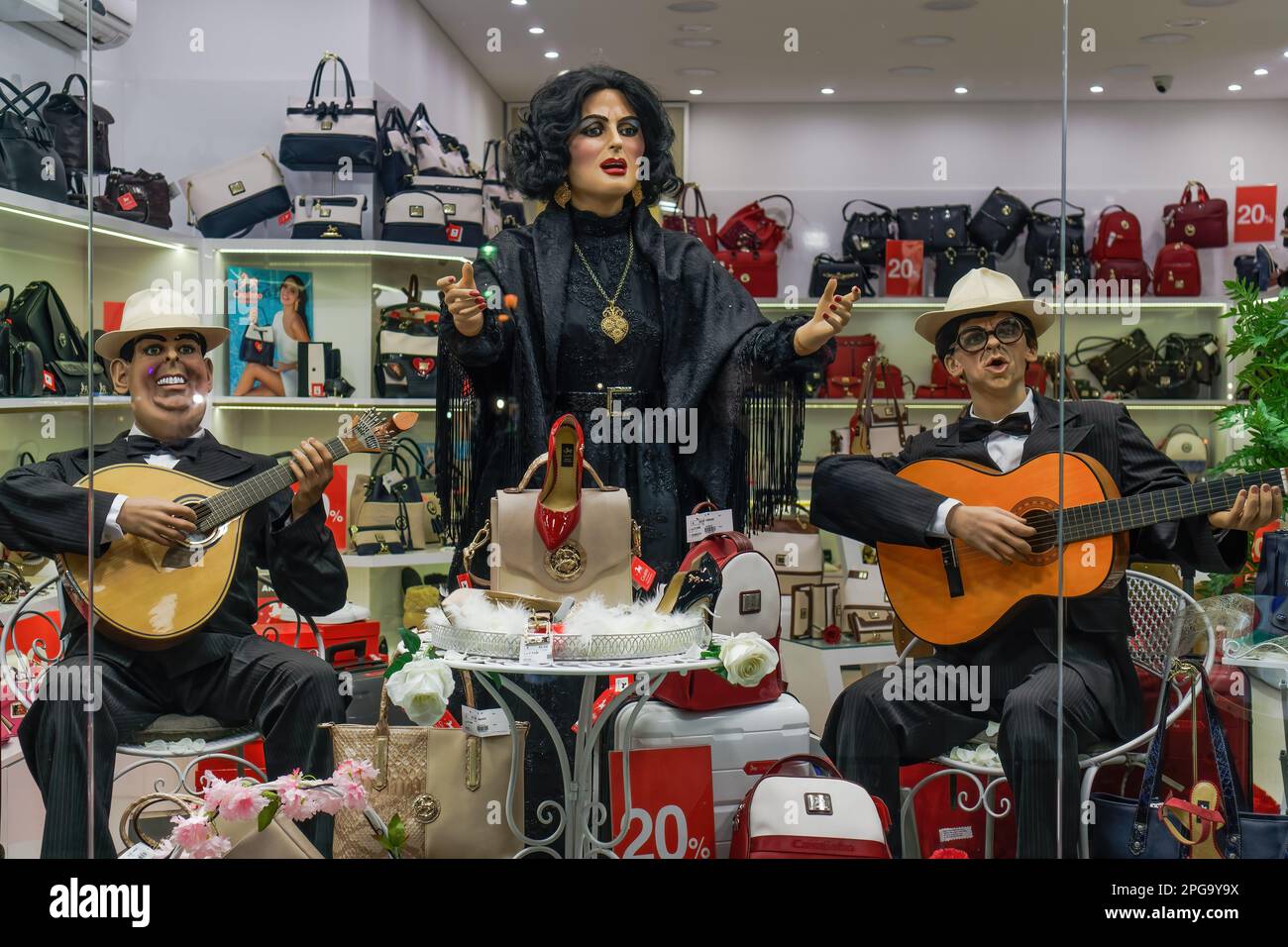 Lisbon, Portugal shop window showcase of dummies depicting a Fado singer accompanied by musicians playing a classic and Portuguese gui Stock Photo