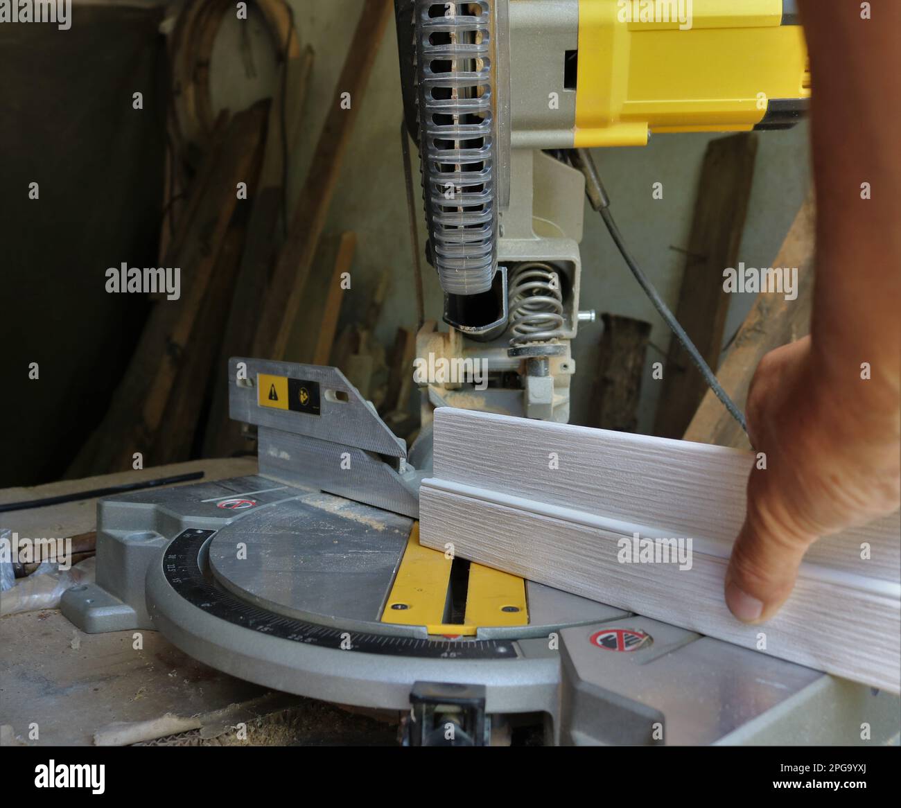 working on a planer saw with wood slats, adjusting the cutting angle on