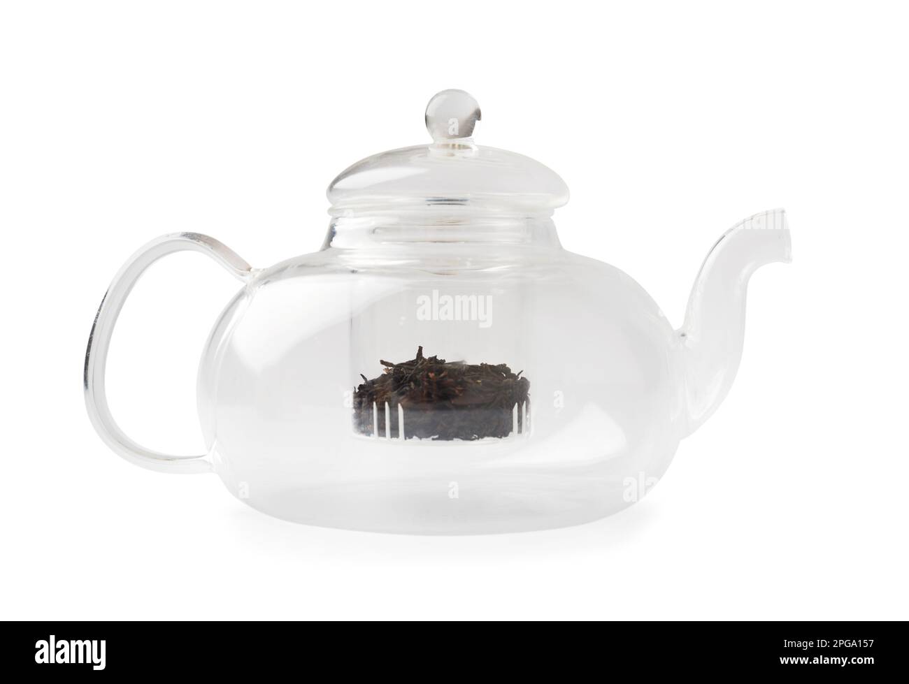 Empty glass transparent teapot and dry green tea in it on a white