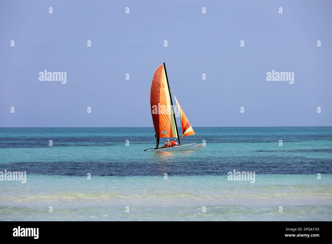 View to sailboat on blue ocean surface. Background for holidays on a sunny beach Stock Photo