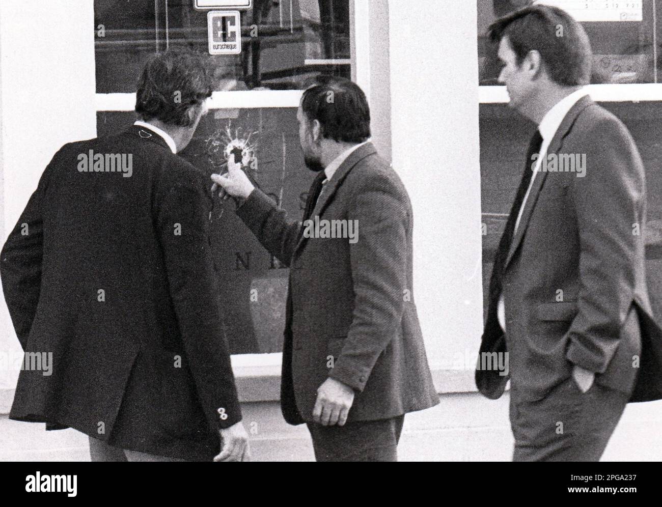 DETECTIVES EXAMINE A GUNSHOT HOLE AT LLOYDS BANK COPNOR AFTER AN ARMED