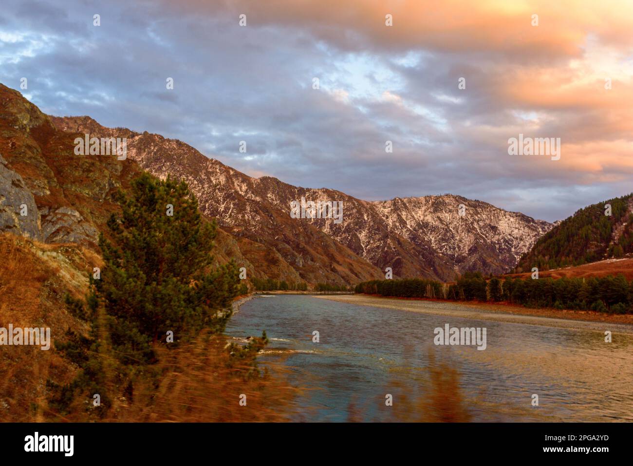 Katun river in Altai with clouds in Siberia in the mountains with snow in autumn. Stock Photo