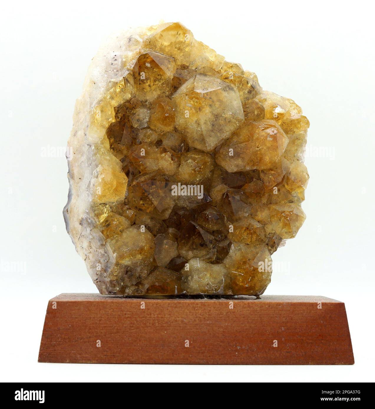 Natural Citrine quartz cluster on a wooden stand Stock Photo