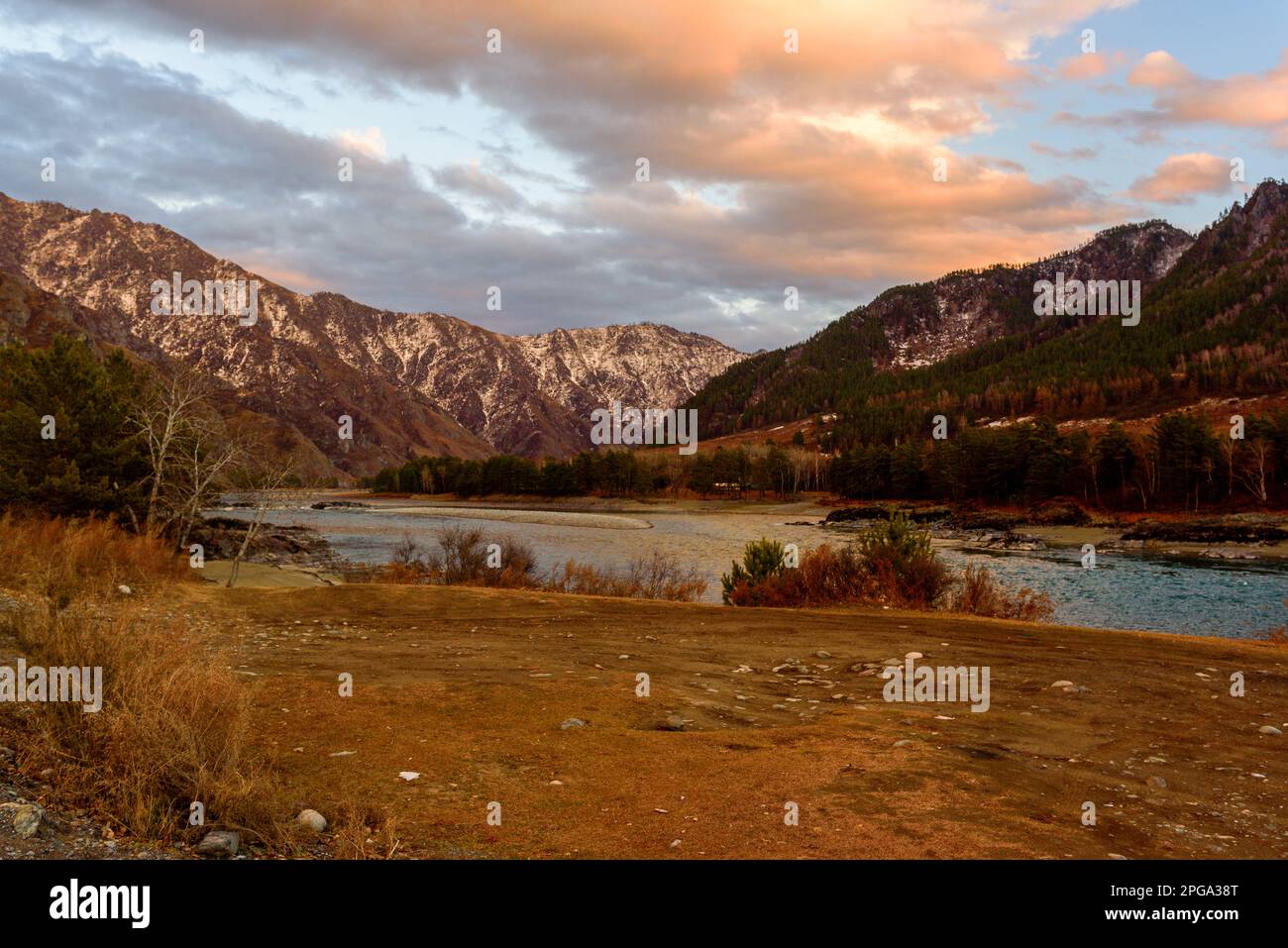 Katun river in Altai with clouds in Siberia in the mountains with snow in autumn at sunset. Stock Photo