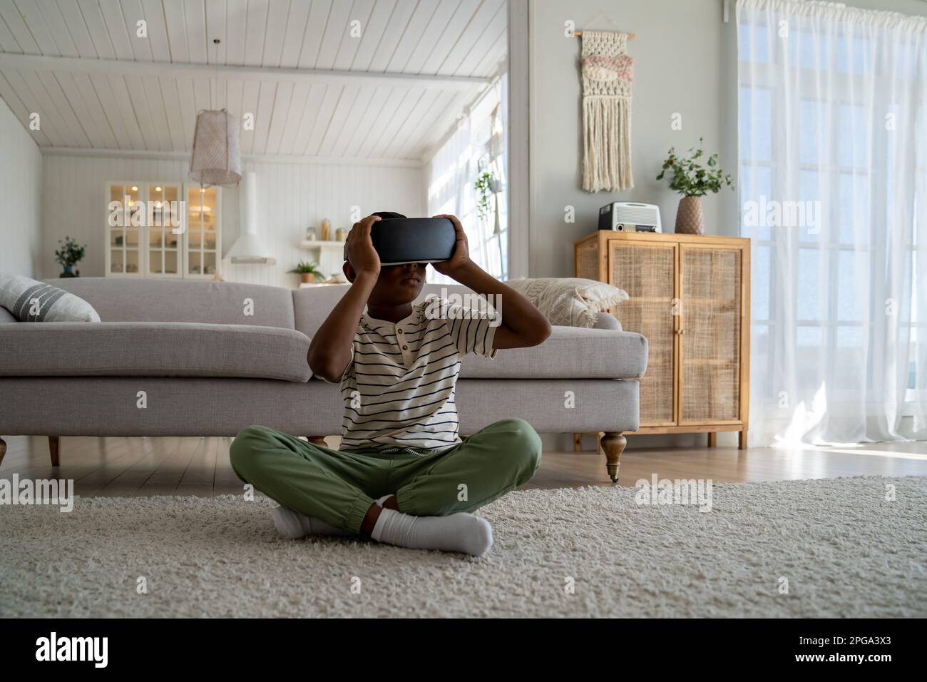African boy sitting on floor hi-res stock photography and images - Alamy