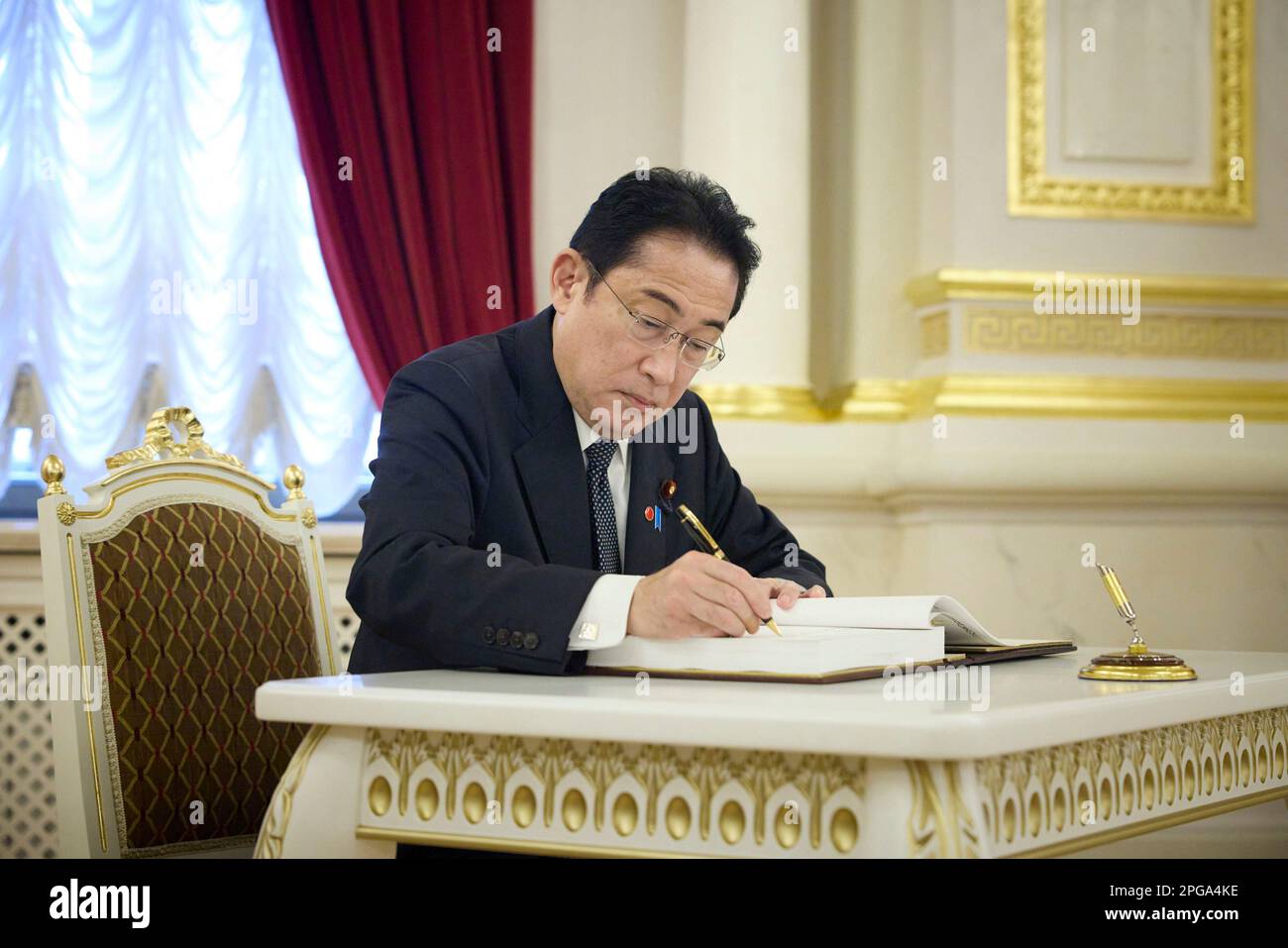 Kyiv, Ukraine. 21st Mar, 2023. Japanese Prime Minister Fumio Kishida, signs the guest book on arrival at the Mariinsky Palace, March 21, 2023 in Kyiv, Ukraine. Credit: Pool Photo/Ukrainian Presidential Press Office/Alamy Live News Stock Photo