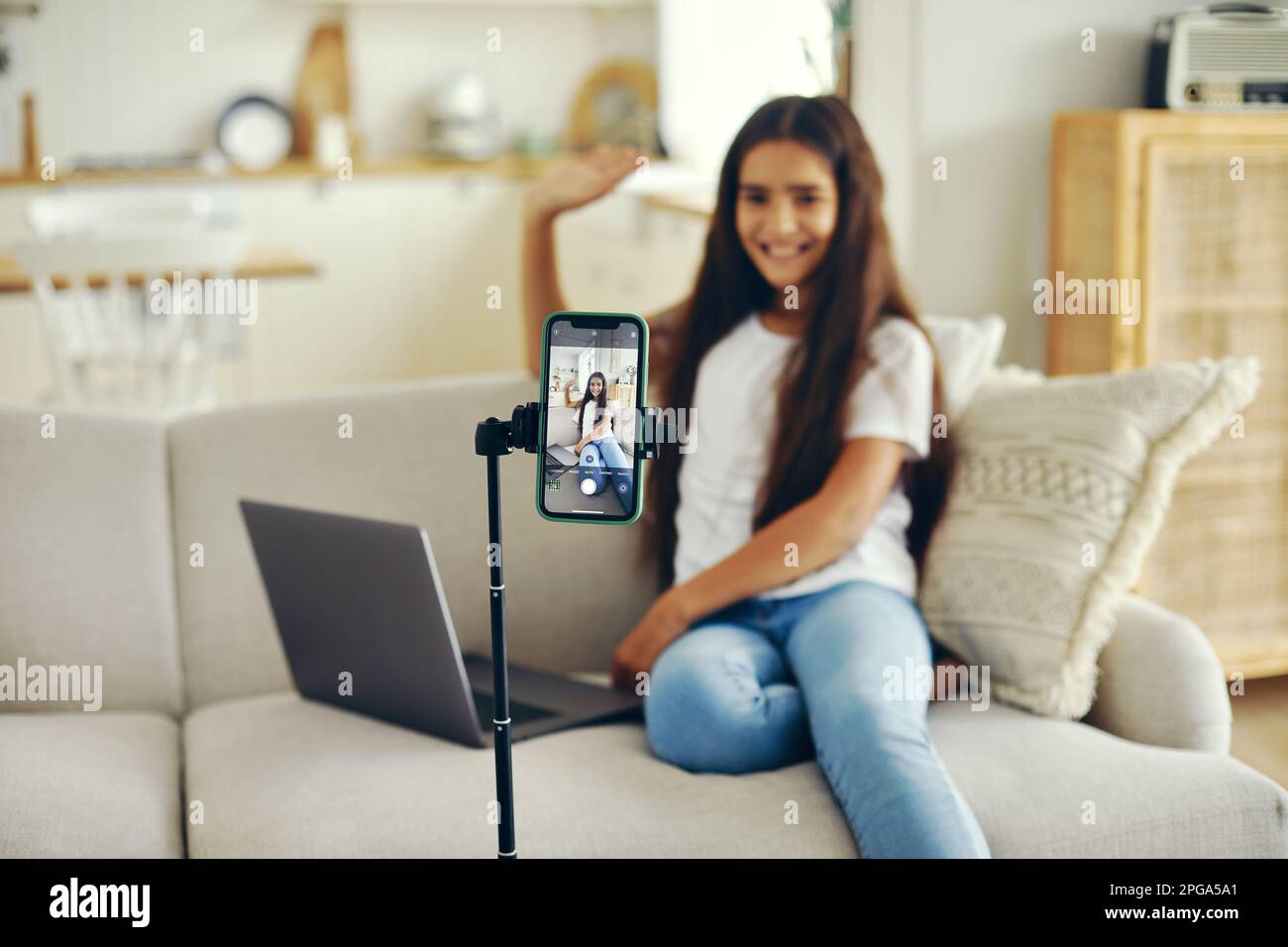 Girl blogger sit on sofa greeting virtual friends, record video for