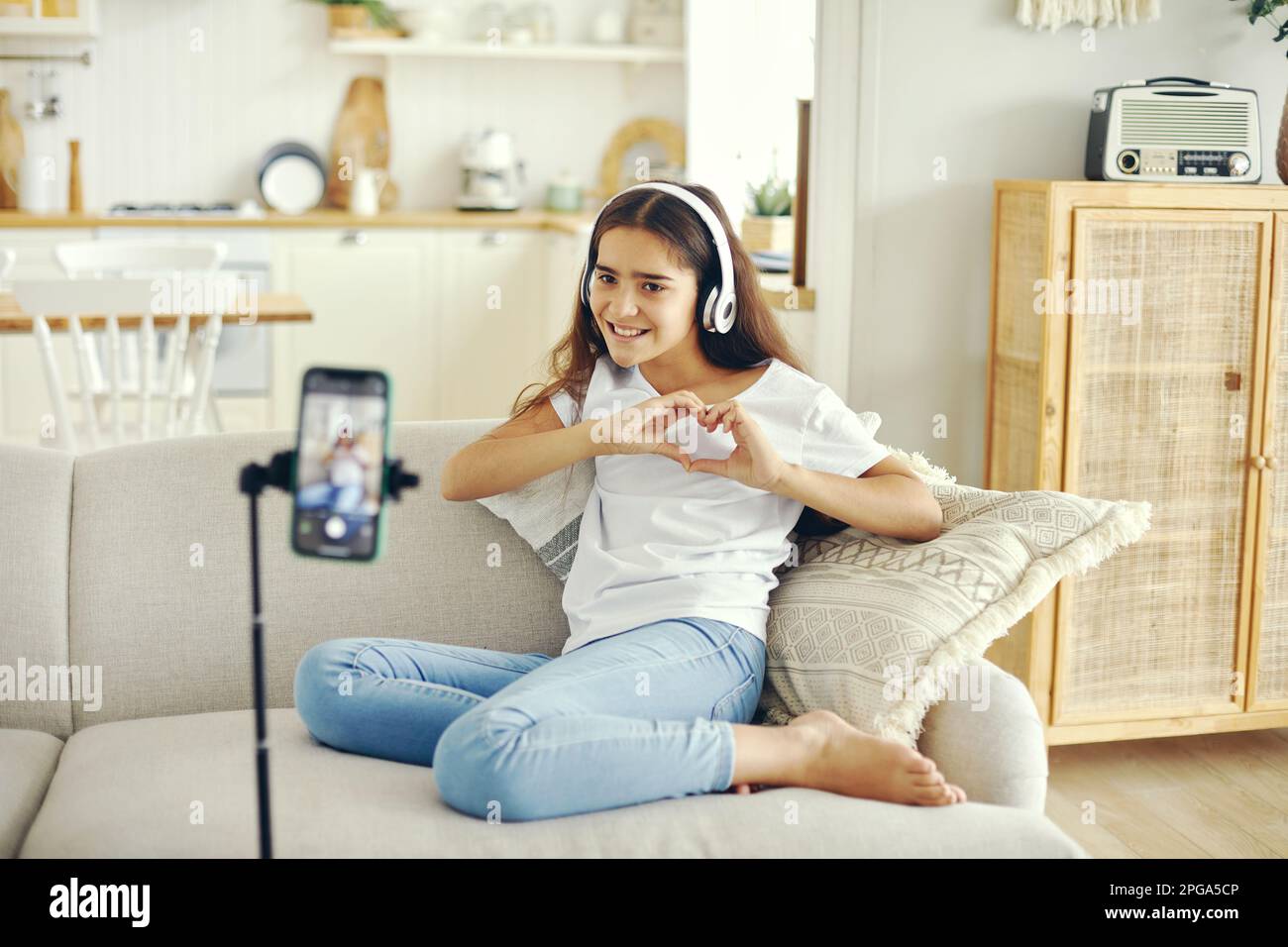 Preteen 12s girl blogger record video for vlog, showing heart sign ...