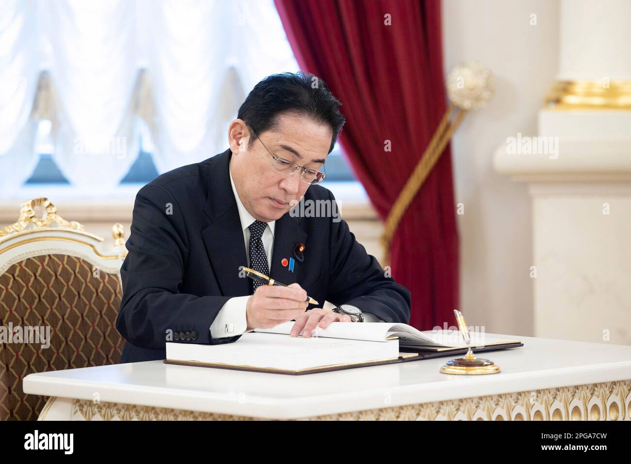 Kyiv, Ukraine. 21st Mar, 2023. Japanese Prime Minister Fumio Kishida signs the guest book on arrival at the Mariinsky Palace, March 21, 2023 in Kyiv, Ukraine. Credit: Planetpix/Alamy Live News Stock Photo