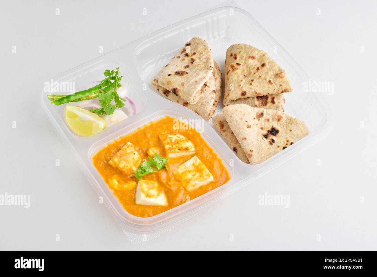 Shahi paneer with tawa roti in disposable plate on white background Stock Photo