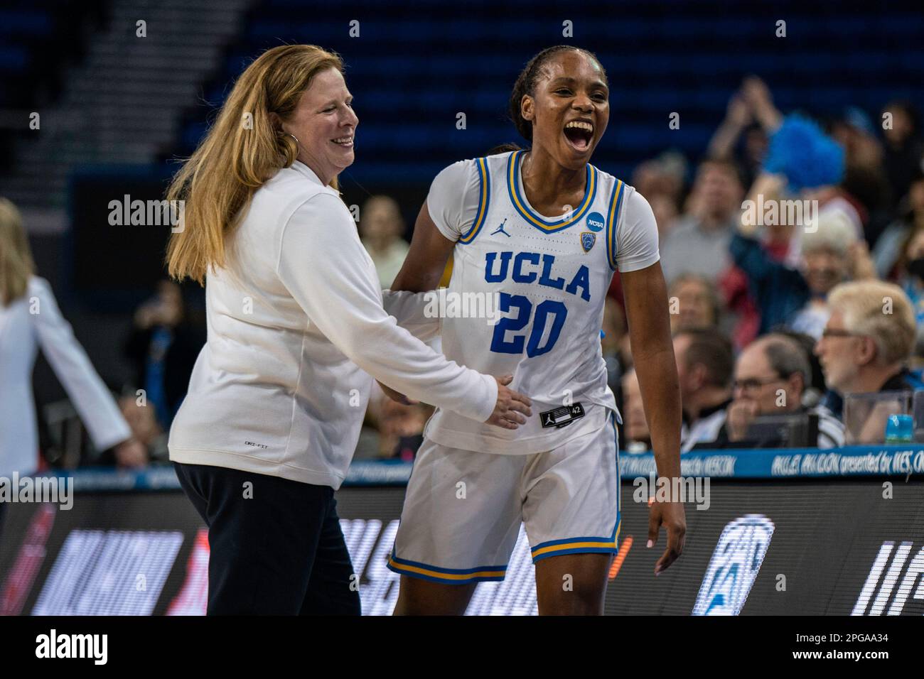 UCLA Bruins guard Charisma Osborne (20) celebrates with head coach Cori Close during a NCAA women’s basketball tournament game against the Oklahoma So Stock Photo