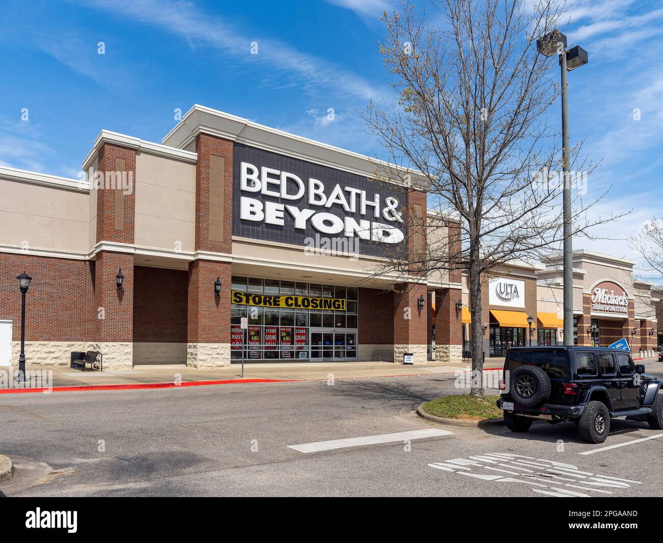 Store Closing sign on Bed Bath and Beyond front exterior showing the corporate logo and sign another business closing in Montgomery Alabama, USA. Stock Photo