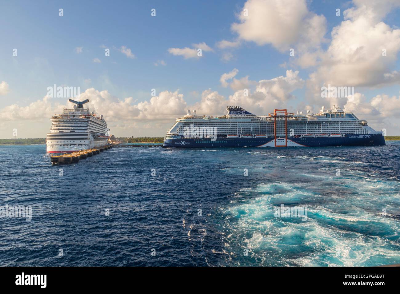 Celebrity BEYOND and Carnival BREEZE cruise ships at Costa Maya Mexico Carbbean Cruise Port and Tourist Location.- viewed from Ruby Princess Cruise Sh Stock Photo