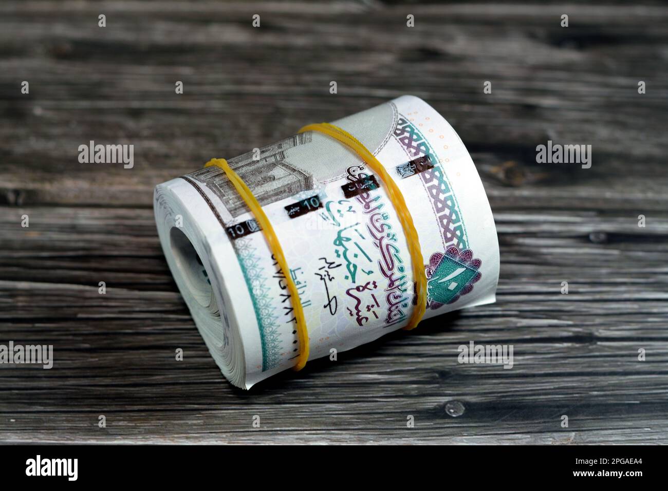10 EGP LE ten Egyptian pounds cash money bills rolled up with rubber ...