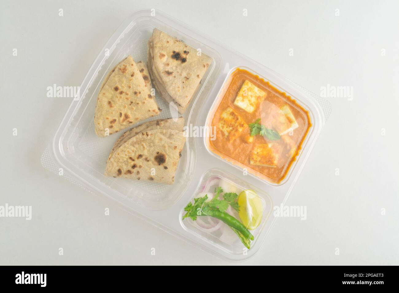 Roti sabji with salad in disposable plate on white background, top view Stock Photo