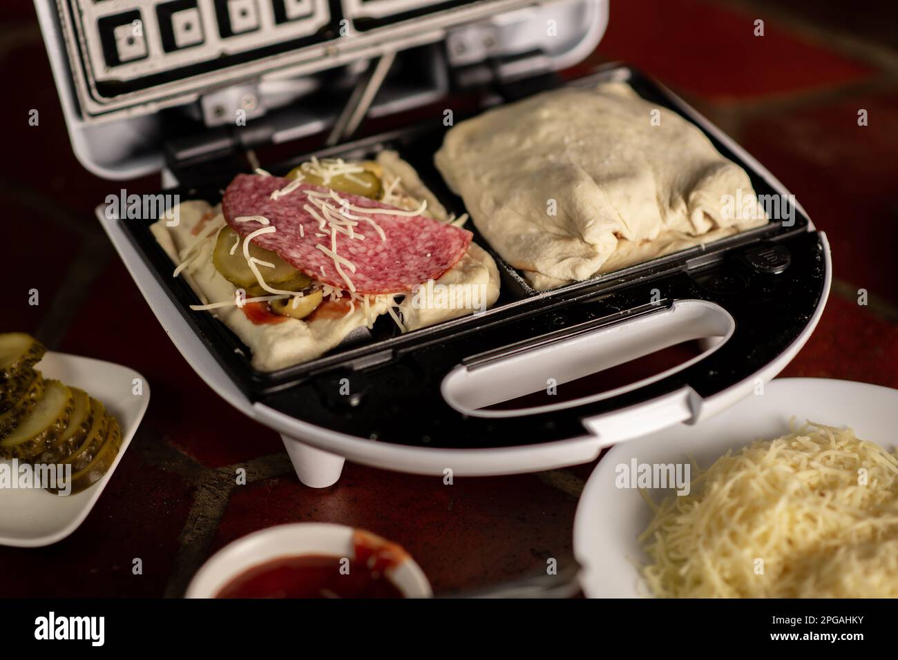 Cooking waffles stuffed with sausage, cheese. Pizza waffle, piffle