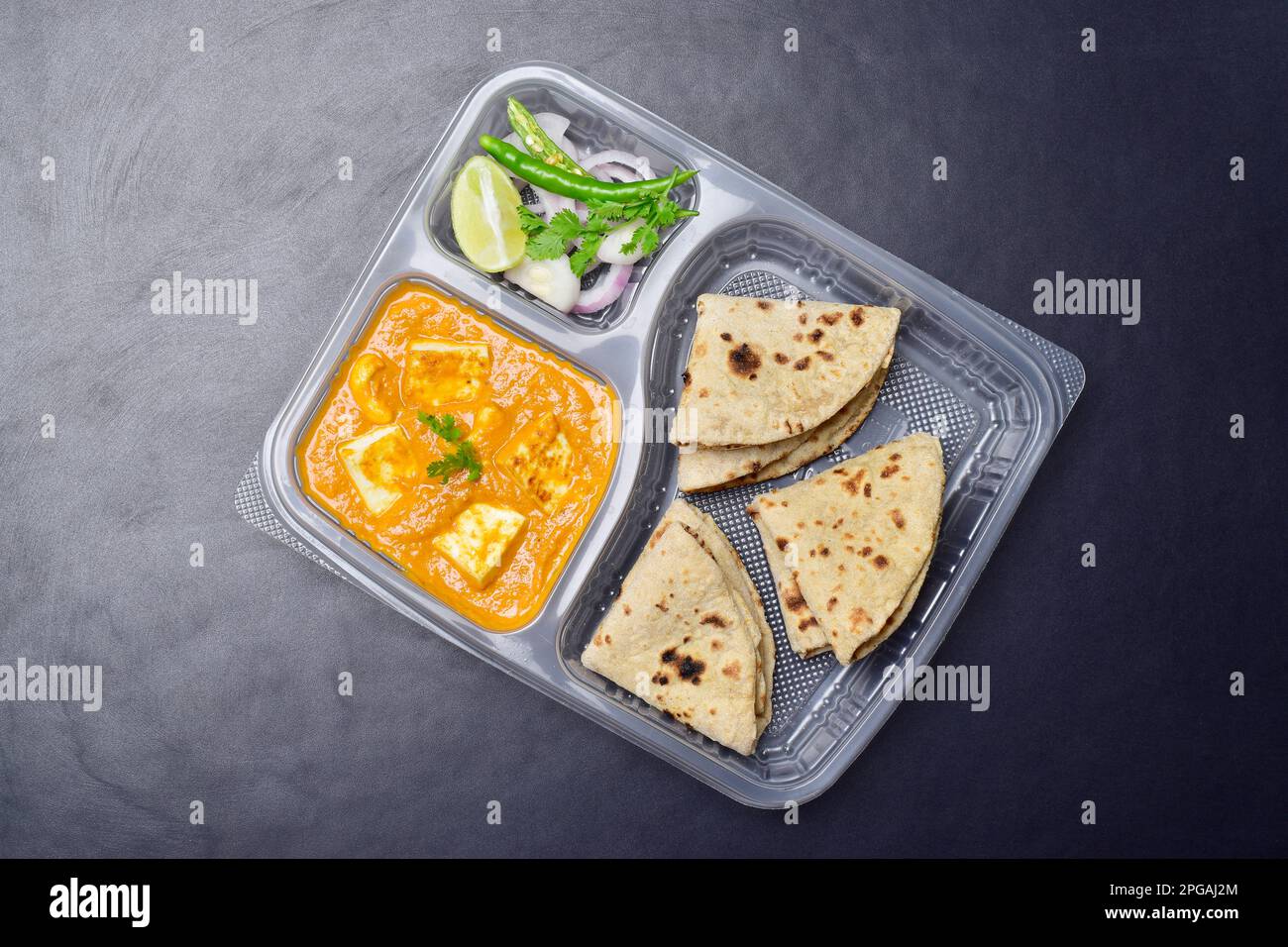 North indian food thali, shahi paneer with tawa roti and salad in disposable plate Stock Photo