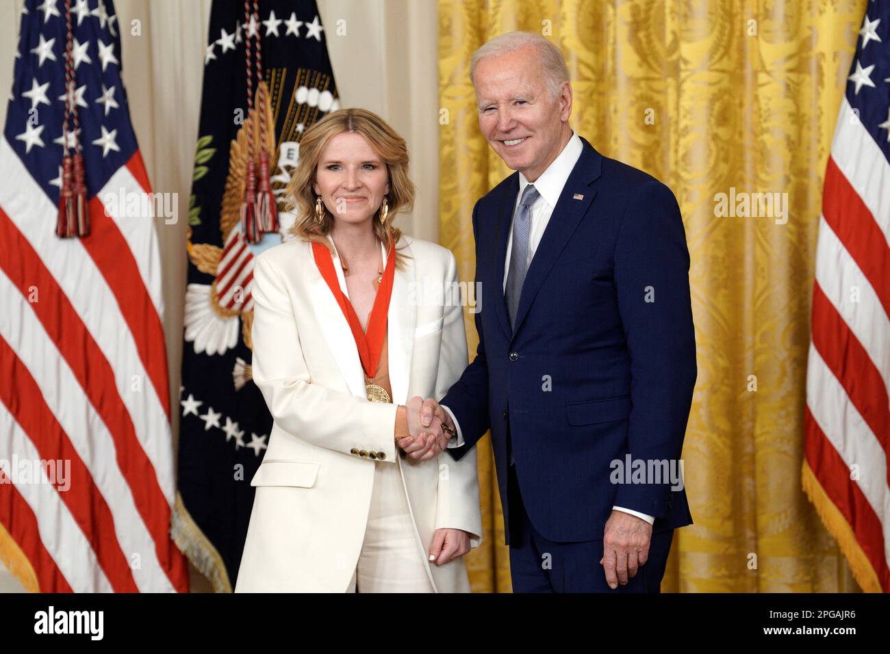 Washington, United States. 21st Mar, 2023. National Humanities Medal recipient author Tara Westover stands on stage with U.S. President Joe Biden during a ceremony in the East Room at the White House in Washington on March 21, 2023. Photo by Yuri Gripas/ABACAPRESS.COM Credit: Abaca Press/Alamy Live News Stock Photo