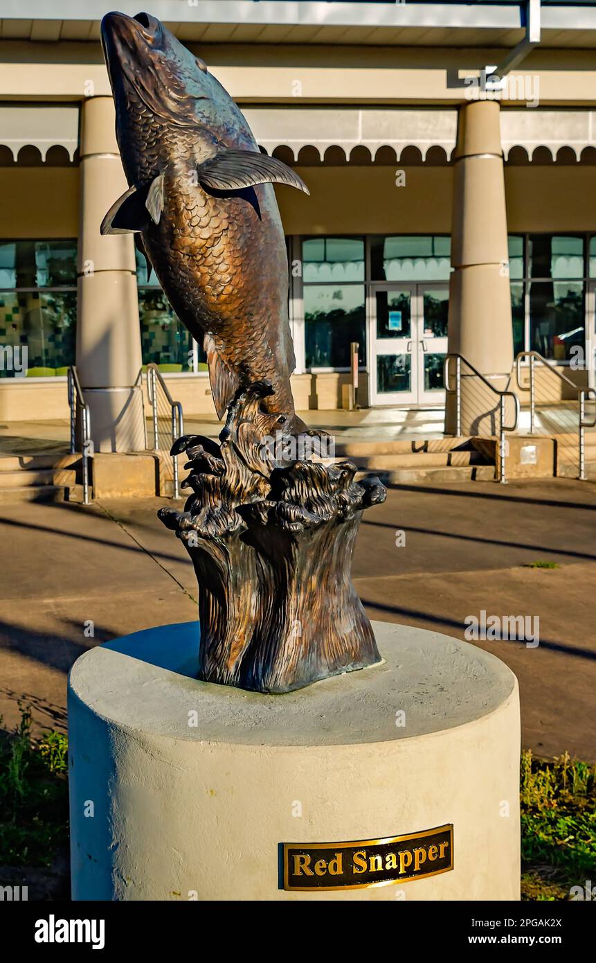 A red snapper sculpture stands in front of the Alabama Center