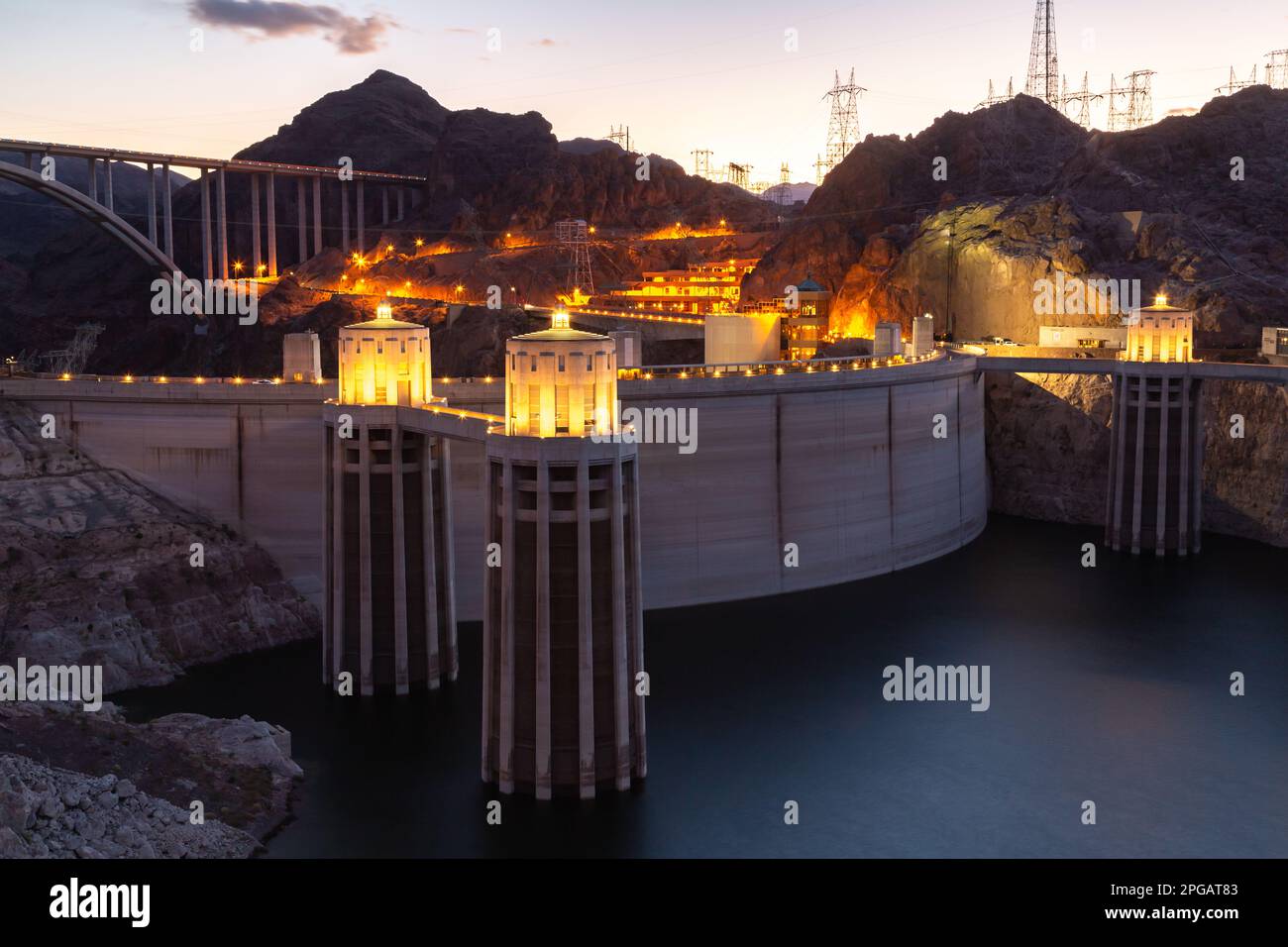 Hoover dam close-up shot. Hoover dam and Lake Mead in Las Vegas area. Large Comstock Intake Towers At Hoover Dam. Hoover Dam in the evening with illuminations without people. Stock Photo