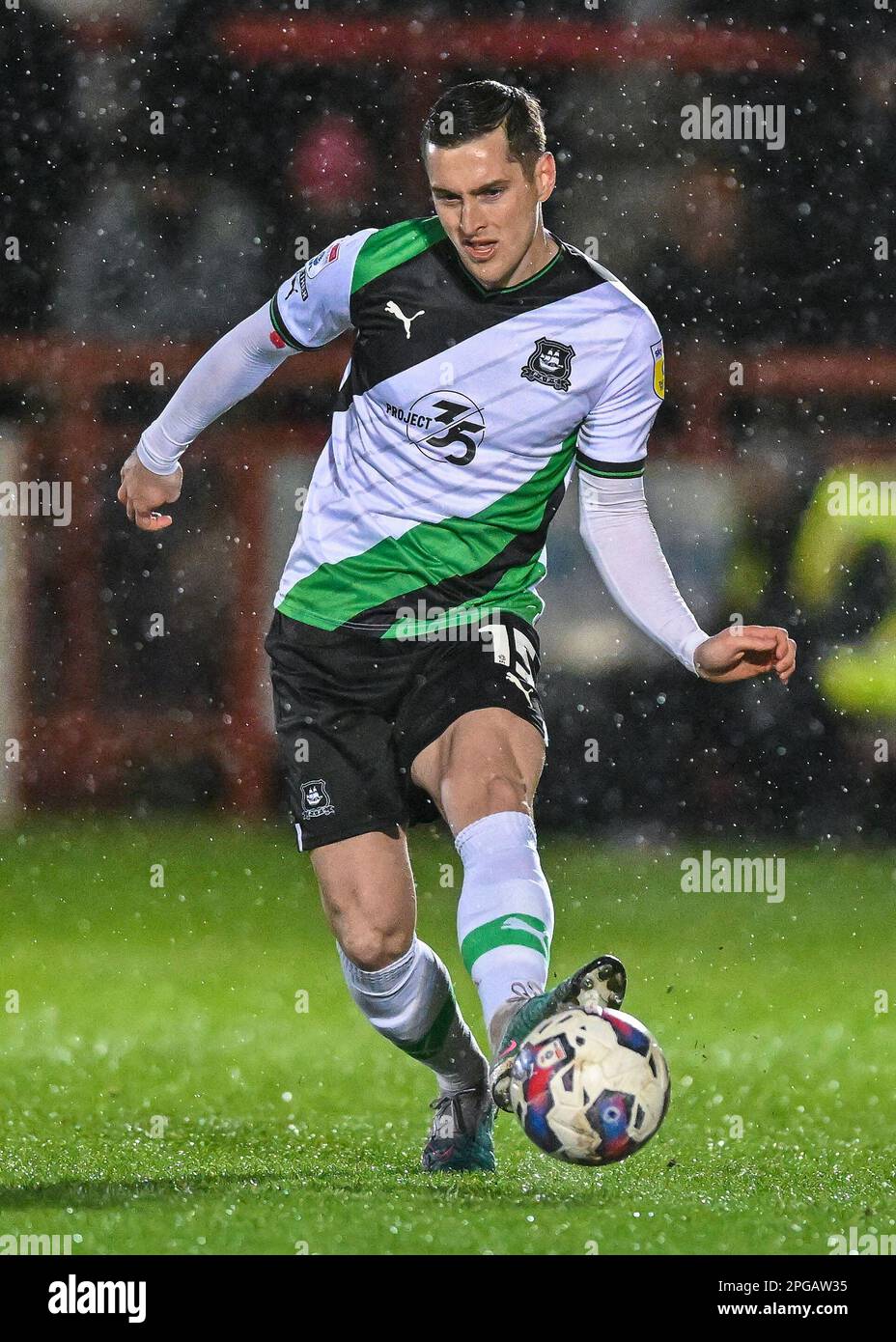 Conor Grant #15 of Plymouth Argyle passes the ball forward during the Sky Bet League 1 match Accrington Stanley vs Plymouth Argyle at Wham Stadium, Accrington, United Kingdom, 21st March 2023  (Photo by Stan Kasala/News Images) Stock Photo