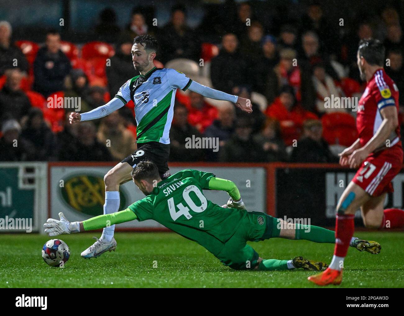 Ryan Hardie #9 of Plymouth Argyle  attacking and Toby Savin #40 of Accrington Stanley makes a save during the Sky Bet League 1 match Accrington Stanley vs Plymouth Argyle at Wham Stadium, Accrington, United Kingdom, 21st March 2023  (Photo by Stan Kasala/News Images) Stock Photo