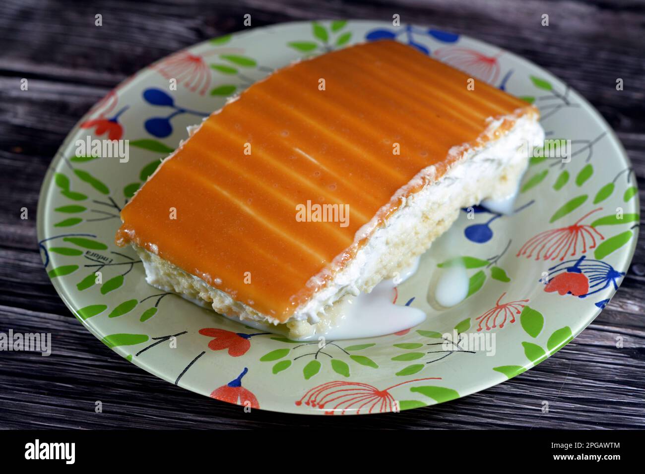 A tres leches cake, pan tres leches, a sponge cake soaked in three kinds of milk, evaporated, condensed and whole milk, covered with whipped cream and Stock Photo