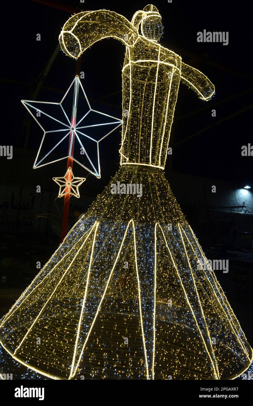 Cairo, Egypt, March 20 2023: Festive decorations in Egyptian streets for Ramadan month in led lights stars and Tanoura dancer a traditional folk dance Stock Photo