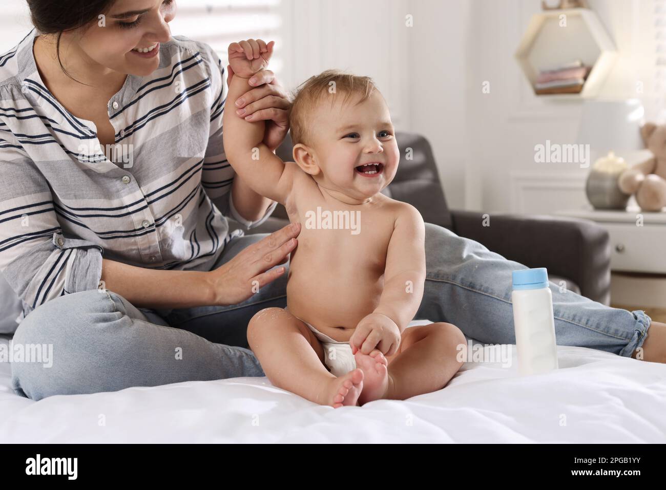 Mother applying dusting powder on her cute baby at home Stock Photo - Alamy