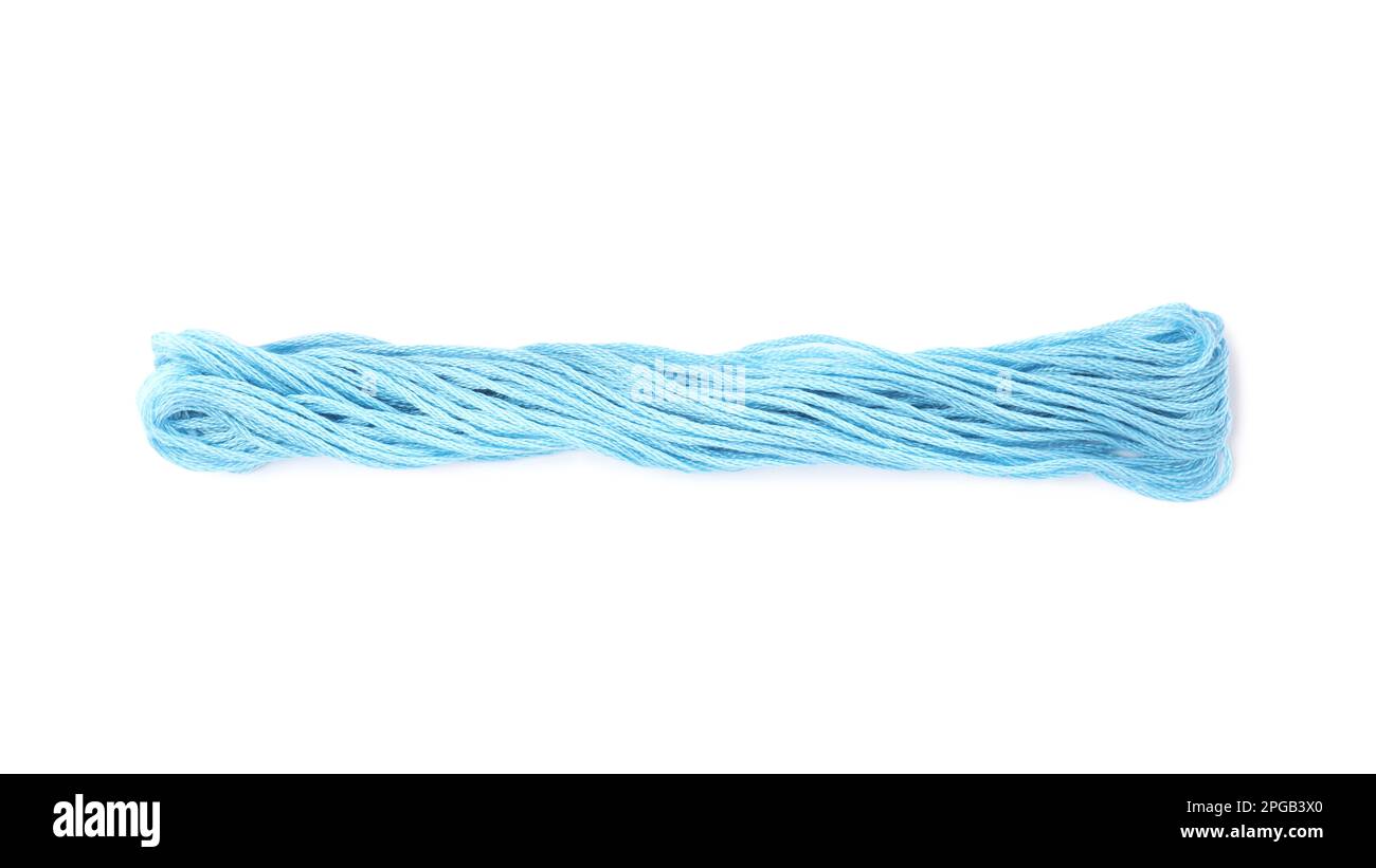 Light blue embroidery thread on white background Stock Photo - Alamy