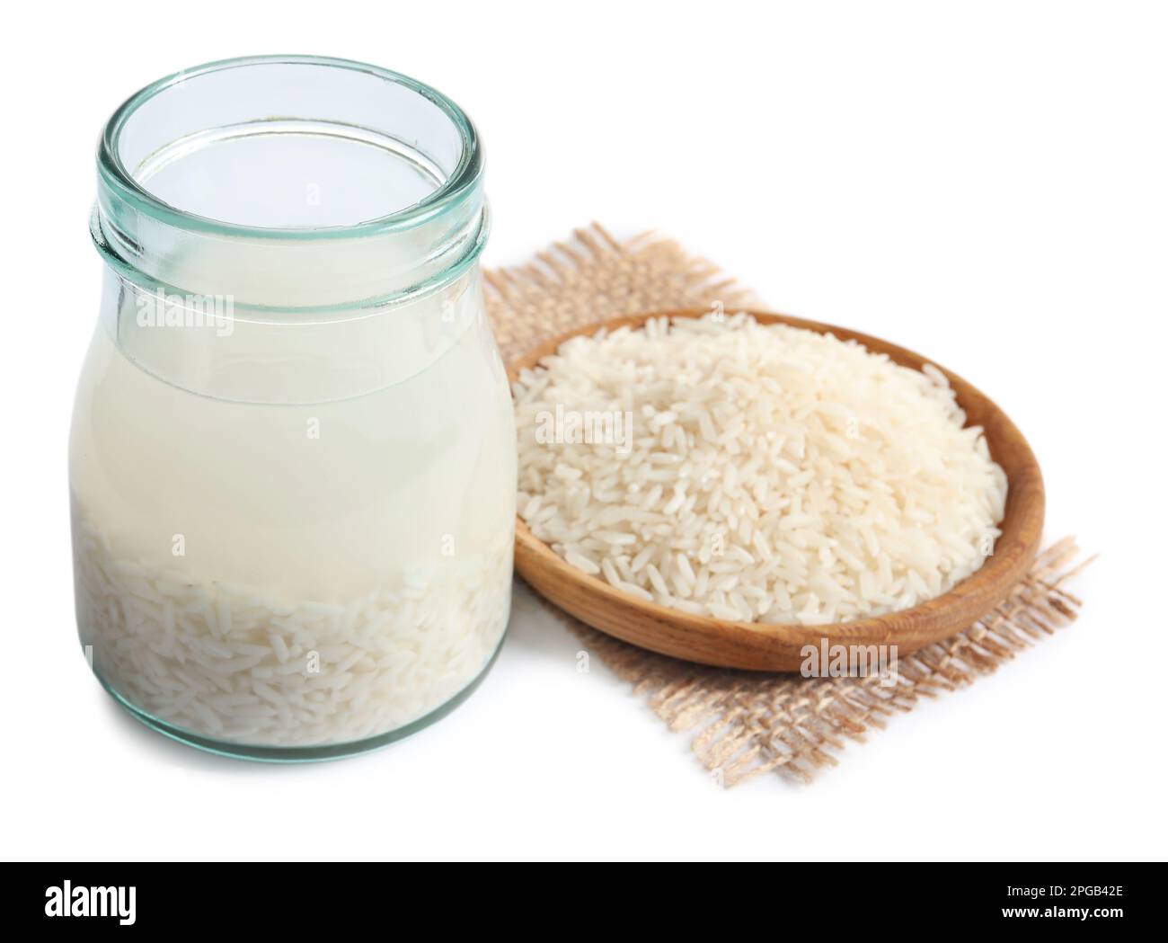Rice soaked in water on white background Stock Photo - Alamy