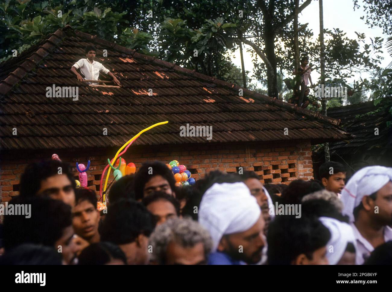 A boy watching the boat race in Aranmula Vallamkali festival or Snake Boat Race in Aranmula, Kerala, India, Asia Stock Photo