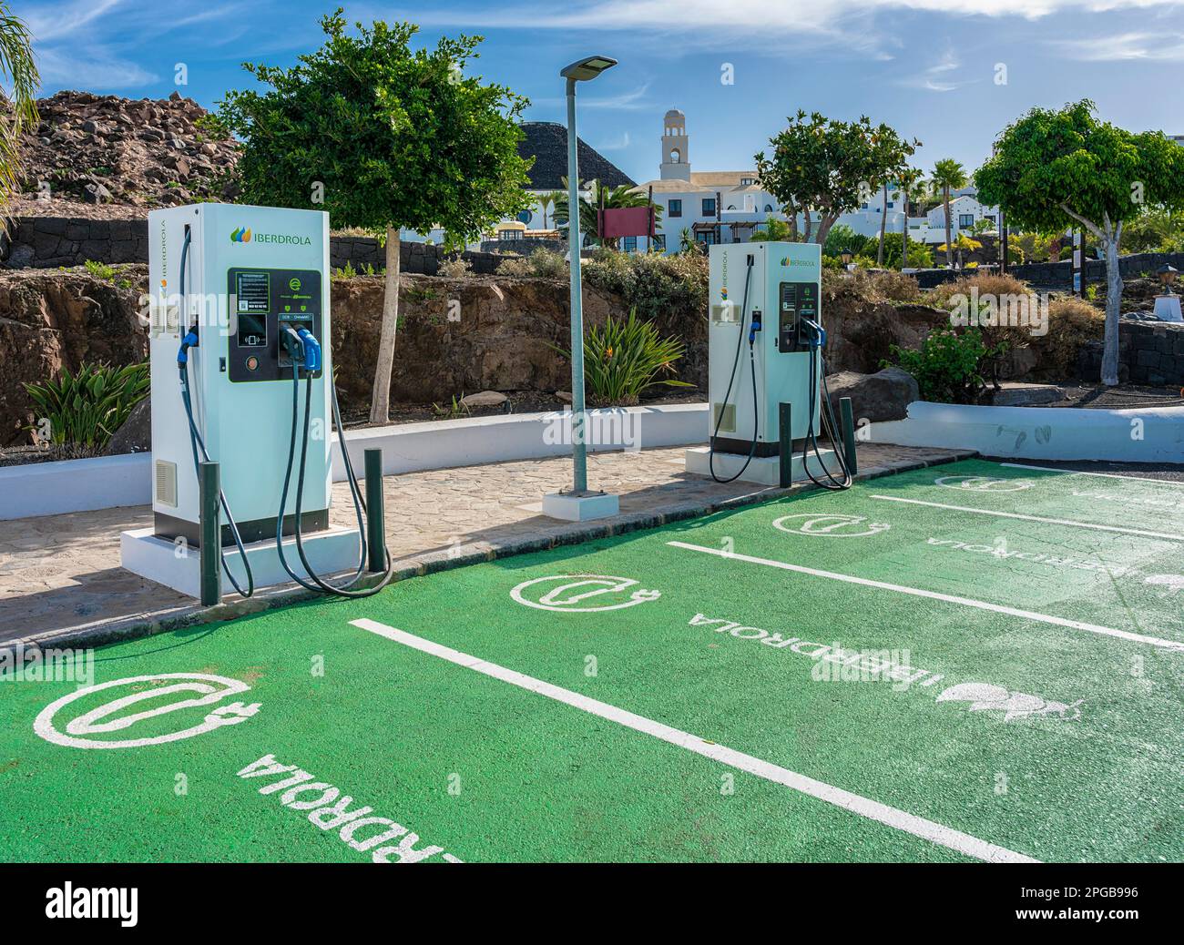 Green parking area with Iberdrola charging station for electric car