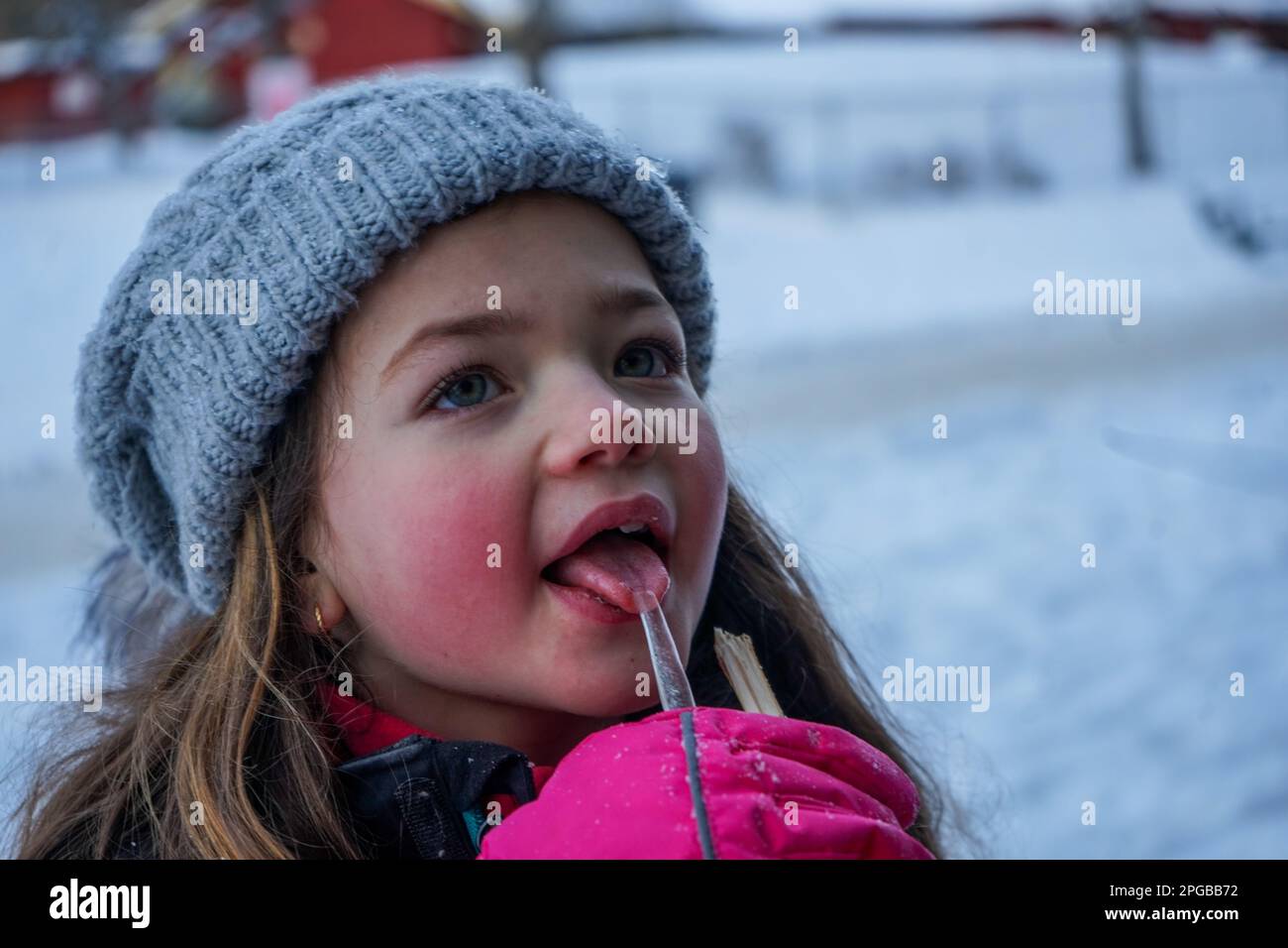 Close up of cute girl licking ice during winter Stock Photo - Alamy