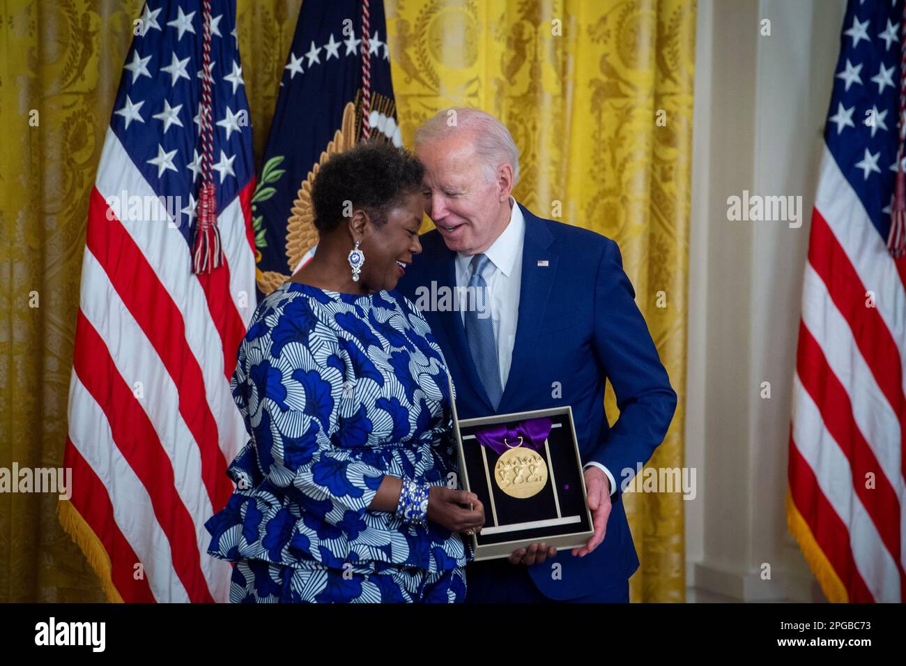 United States President Joe Biden presents the Arts and Humanities Award to Denise Saunders Thompson on behalf of The International Association of Blacks in Dance, during a ceremony in the East Room of the White House in Washington, DC on Tuesday, March 21, 2023. The National Medal of Arts is the highest award given to artists and arts patrons by the federal government. It is awarded by the president of the United States to individuals or groups who are deserving of special recognition by reason of their outstanding contributions to the excellence, growth, support, and availability of the arts Stock Photo