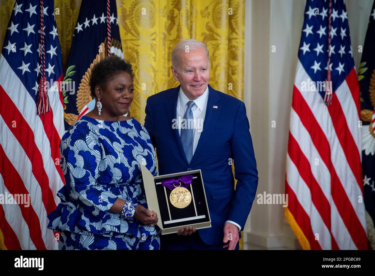 United States President Joe Biden presents the Arts and Humanities Award to Denise Saunders Thompson on behalf of The International Association of Blacks in Dance, during a ceremony in the East Room of the White House in Washington, DC on Tuesday, March 21, 2023. The National Medal of Arts is the highest award given to artists and arts patrons by the federal government. It is awarded by the president of the United States to individuals or groups who are deserving of special recognition by reason of their outstanding contributions to the excellence, growth, support, and availability of the arts Stock Photo