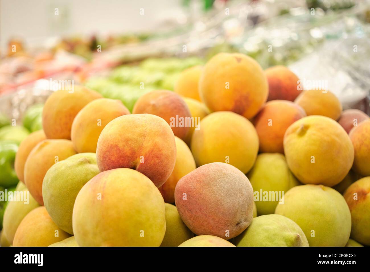 Stack of peaches in a fruit store. Bright image with copy space. Stock Photo
