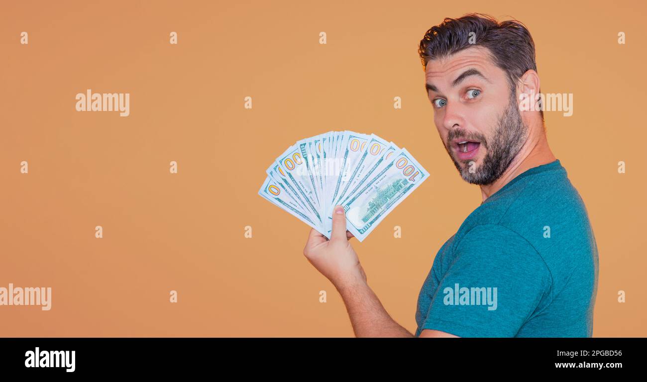 Man with cash money in dollar banknotes on isolated studio banner. Portrait of businessman with dollar banknotes. Dollar money. Cash dollar banner. Stock Photo