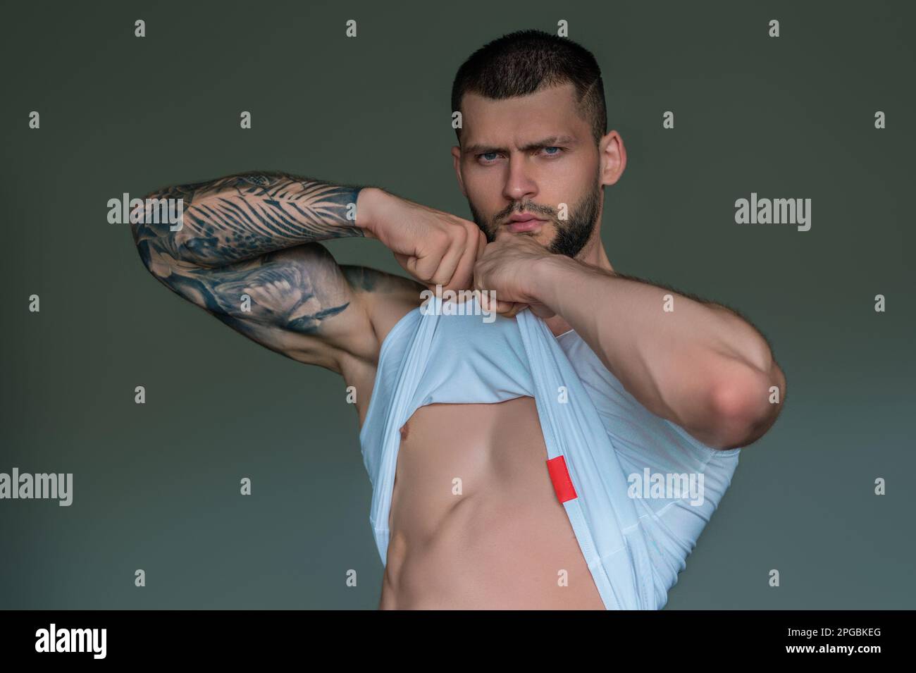 Handsome muscular man showing sexy body. Young sexy man portrait. Sexy guy with athletic flexing muscles. Sexy young handsome naked man. Seductive gay Stock Photo