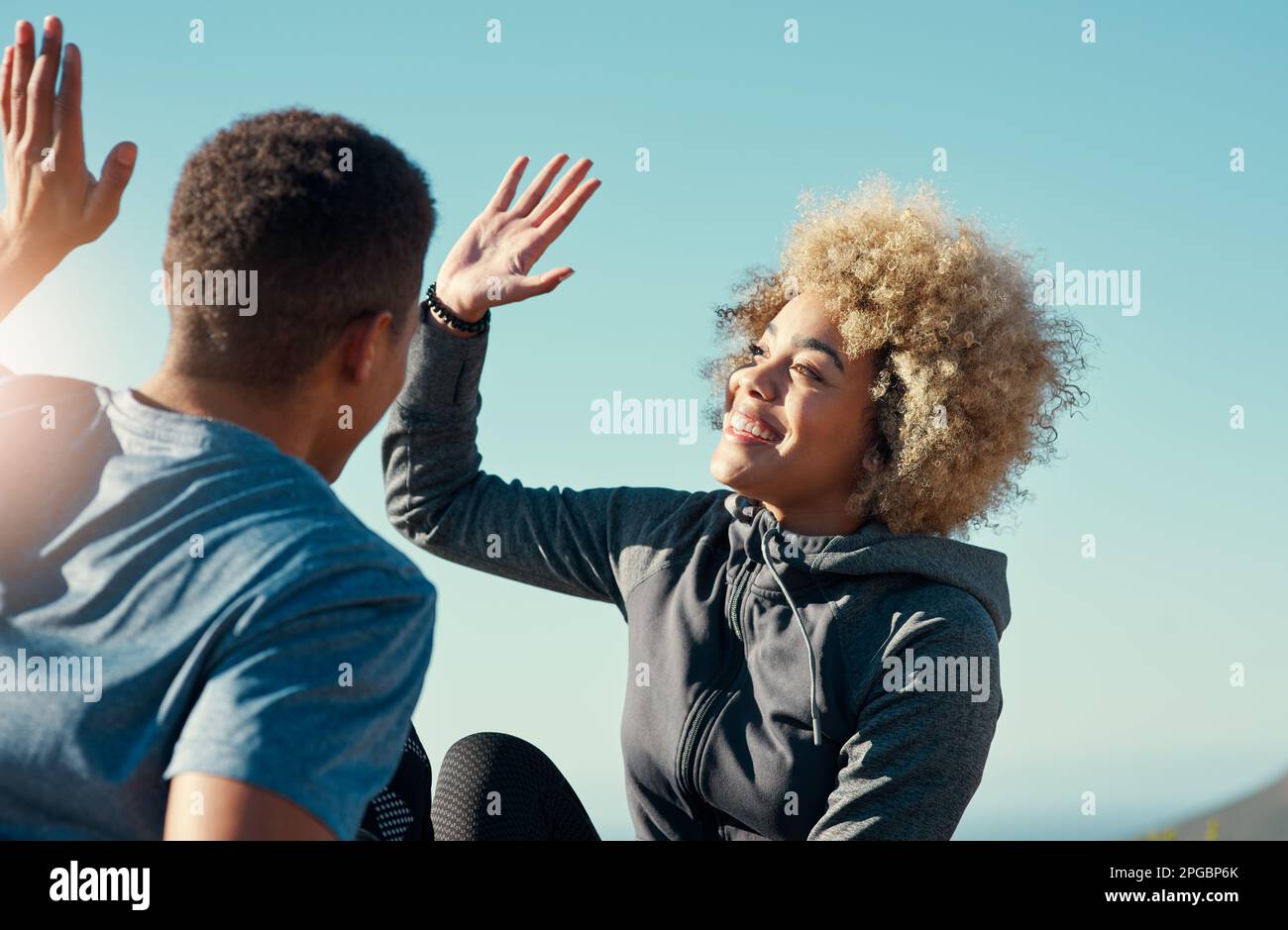 We did it together. a young couple giving each other other five while ...