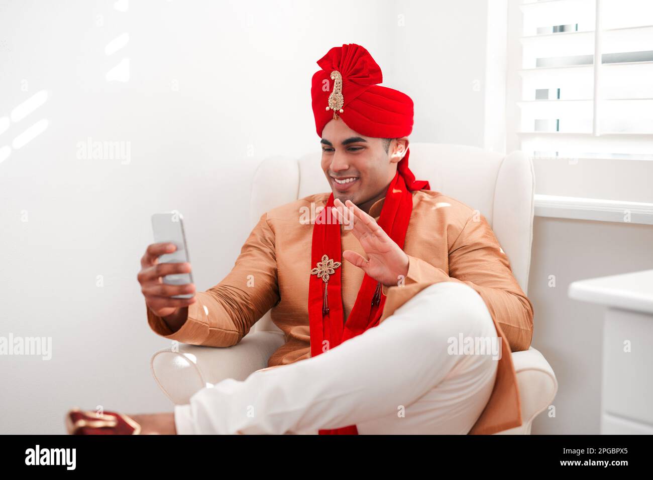 Bye bye bachelorhood, hello happily ever after. a young man waving while using a smartphone on his wedding day. Stock Photo