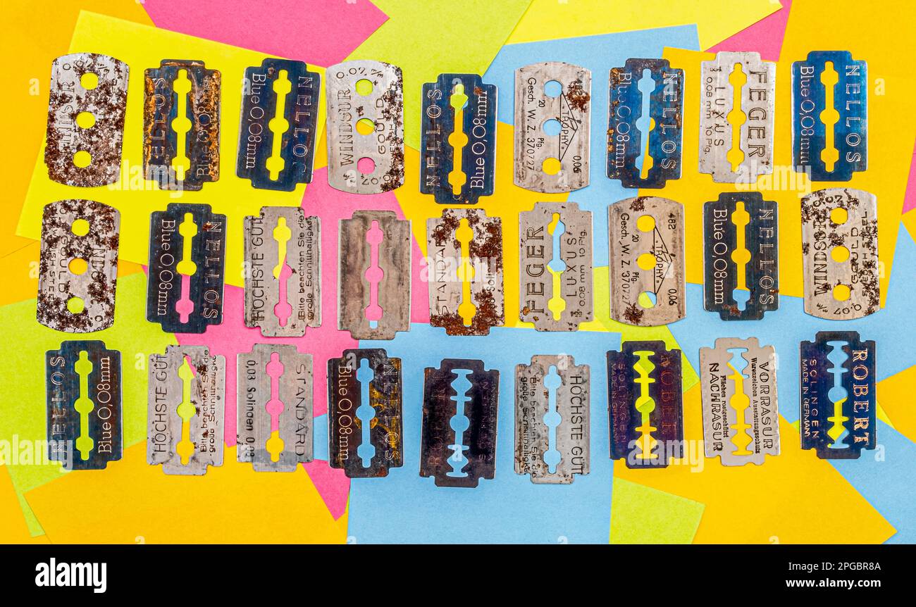 old vintage razor shaving blade on multicolored paper sticky notes ...