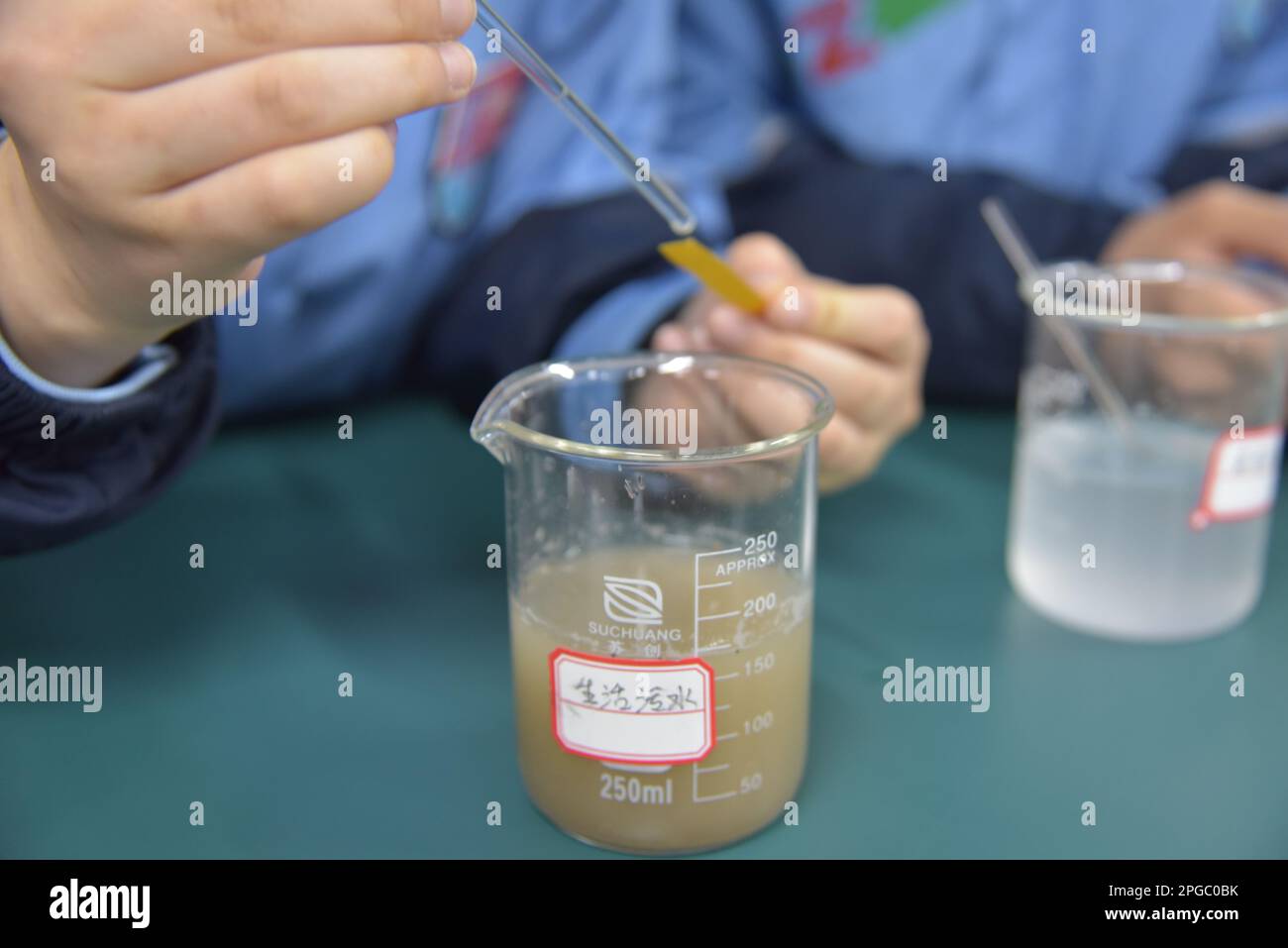 BAZHOU, CHINA - MARCH 22, 2023 - A student performs a PH test on a common wastewater in Bazhou, Xinjiang Province, China, March 22, 2023. March 22, 20 Stock Photo