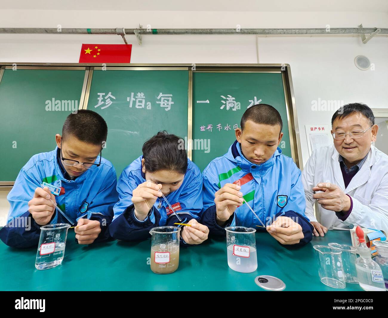 BAZHOU, CHINA - MARCH 22, 2023 - Students perform a PH test on a common wastewater in Bazhou, Xinjiang Province, China, March 22, 2023. March 22, 2023 Stock Photo