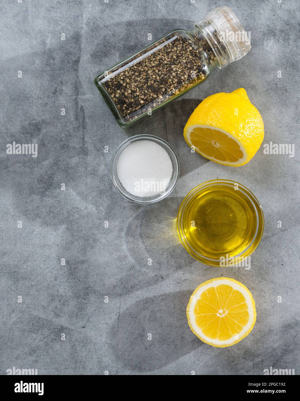https://c8.alamy.com/comp/2PGC192/salt-black-pepper-olive-oil-and-lemon-close-up-view-from-above-copy-space-2PGC192.jpg