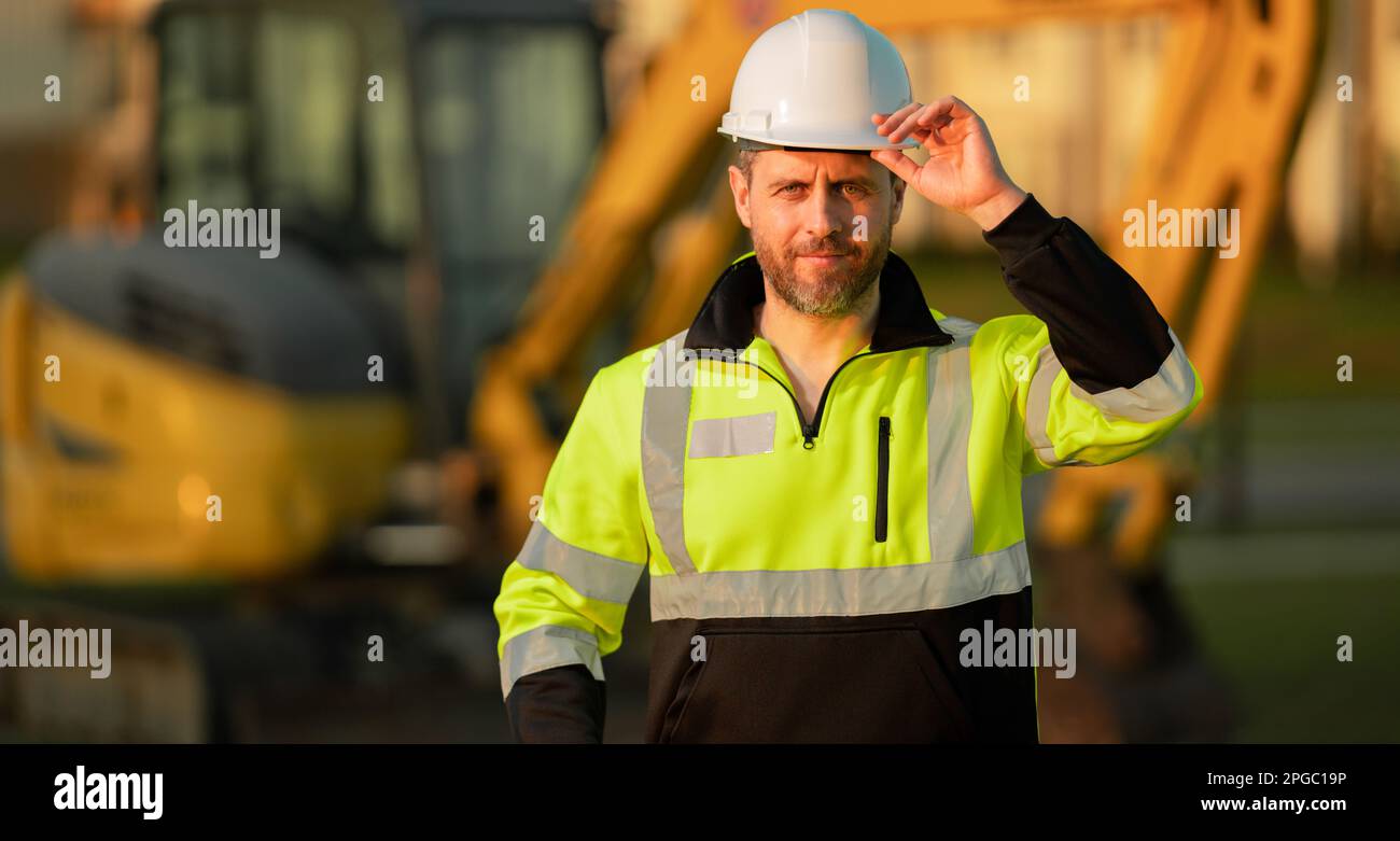 Worker at construction site. Builder constructor in hardhat. Construction man with helmet. Worker at construction with helmet. Industry worker at Stock Photo