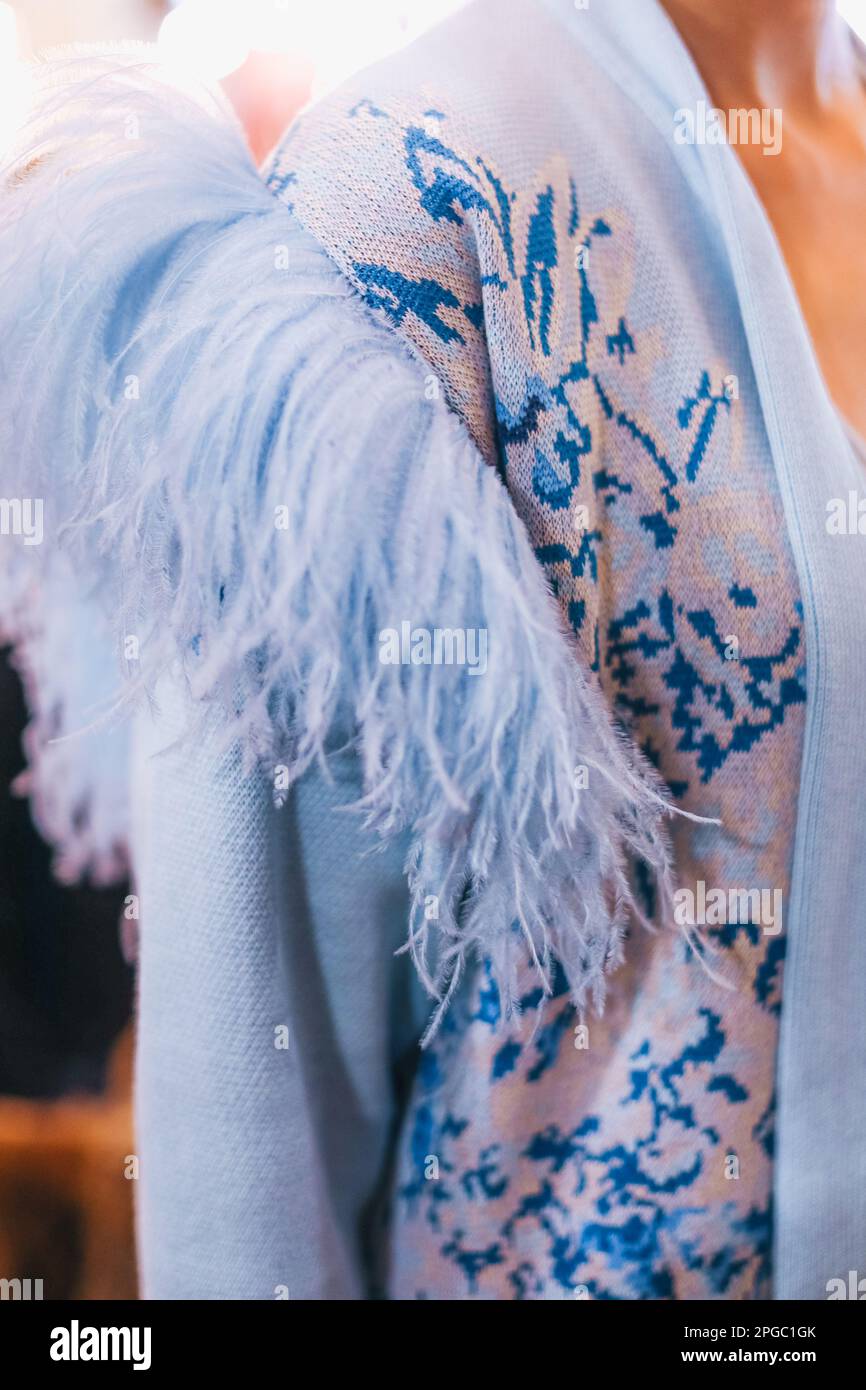 Details of knitting blue elegant autumn cardigan with feathers. Fashion collection Stock Photo