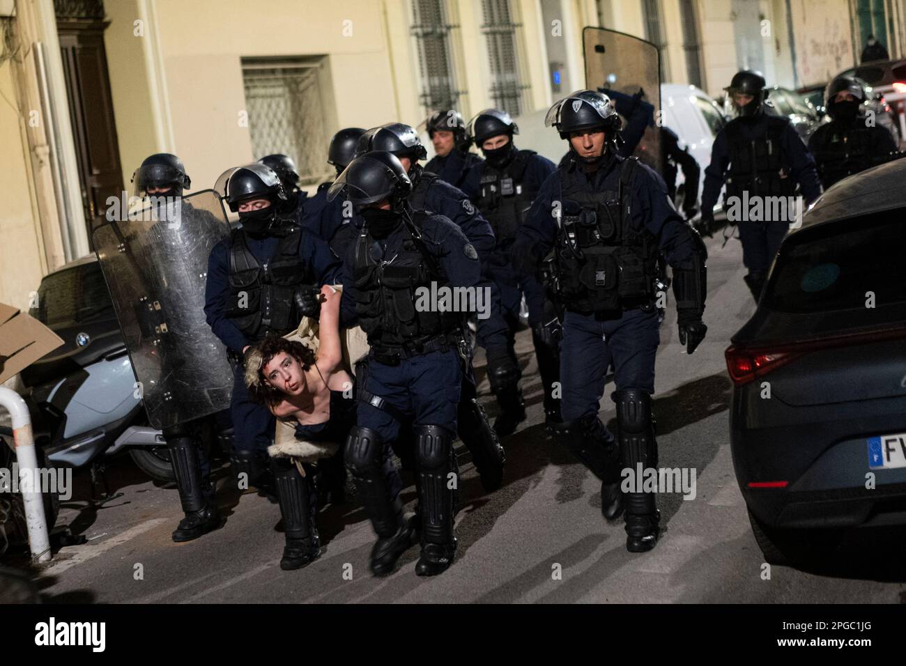 A carnival goer is arrested by French riot police during Marseille's ...