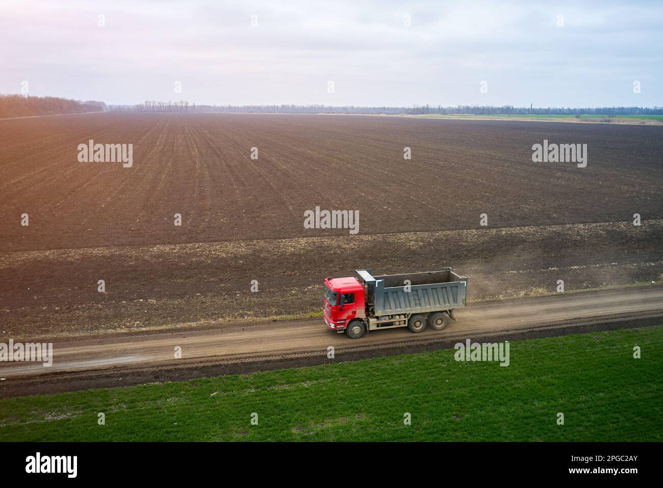 view from a drone of a dump truck moving along a field road Stock Photo